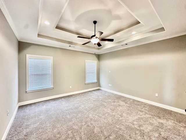 a view of an empty room with a window and fireplace