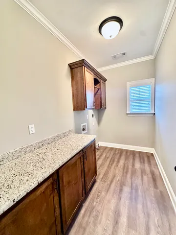 a kitchen with a sink and a wooden floor