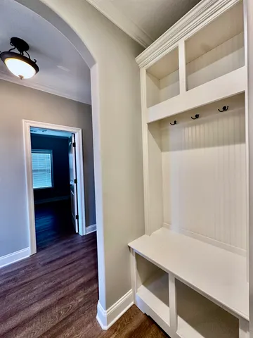 a view of a hallway with wooden floor