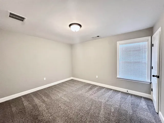 an empty room with a empty space and a window