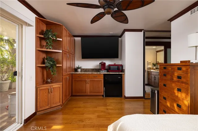 a kitchen with stainless steel appliances kitchen island granite countertop a refrigerator and microwave