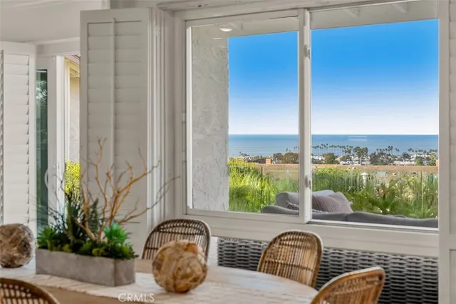 a view of a balcony with furniture and floor to ceiling window