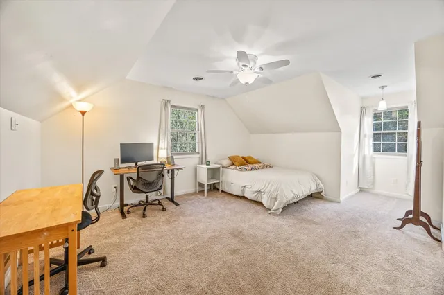 a bed room with a bed and a chair