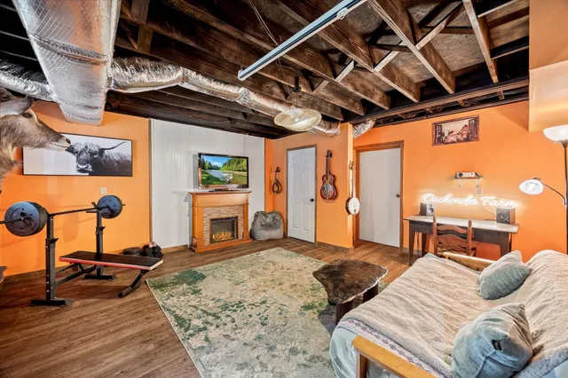 a bedroom with furniture and a fireplace