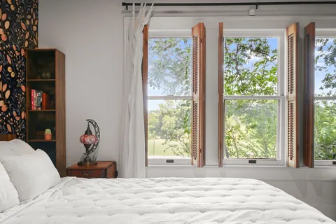a bedroom with furniture and a window