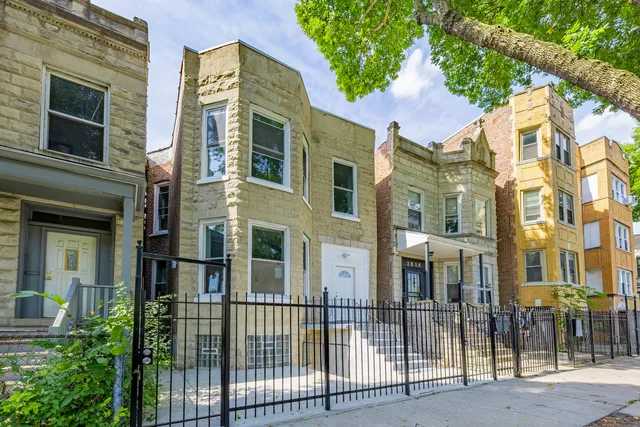a view of a brick building next to a yard