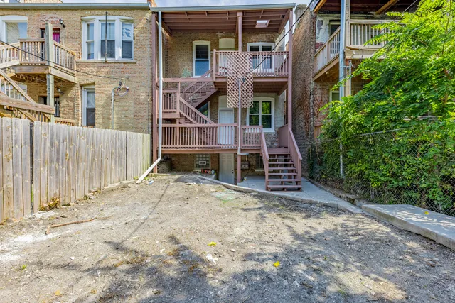 a view of a house with wooden fence