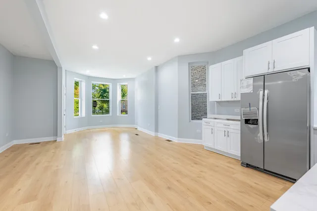 a kitchen with stainless steel appliances a refrigerator and a stove top oven