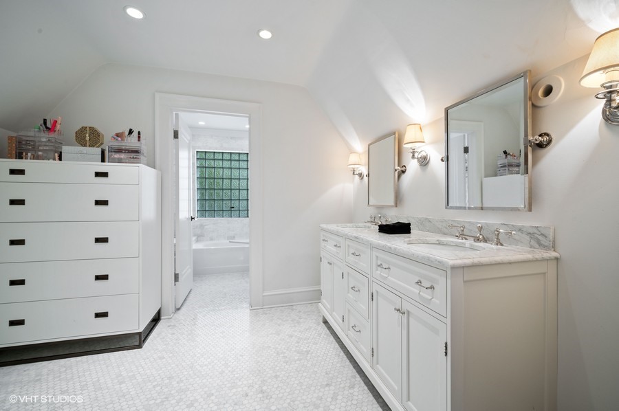 111 Robsart Road Kenilworth, IL 60043 - Photo 37 of 49 a bathroom with a double vanity sink a mirror and a bathtub