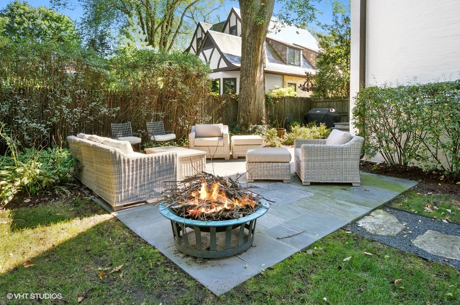 111 Robsart Road Kenilworth, IL 60043 - Photo 45 of 49 a view of a patio with couches and a table and chairs and plants