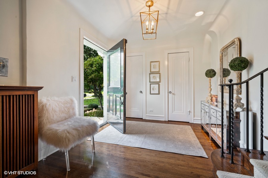 111 Robsart Road Kenilworth, IL 60043 - Photo 6 of 49 a view of a hallway with wooden floor and stairs