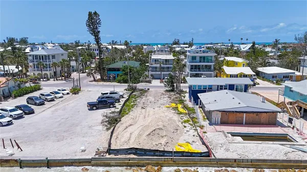 a aerial view of a house with a garden and lake view