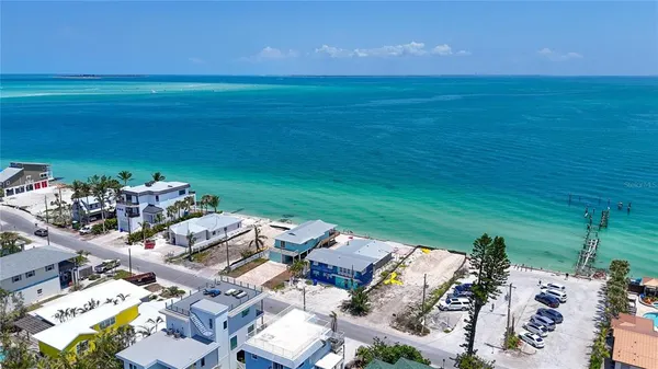 an aerial view of a house with a ocean view