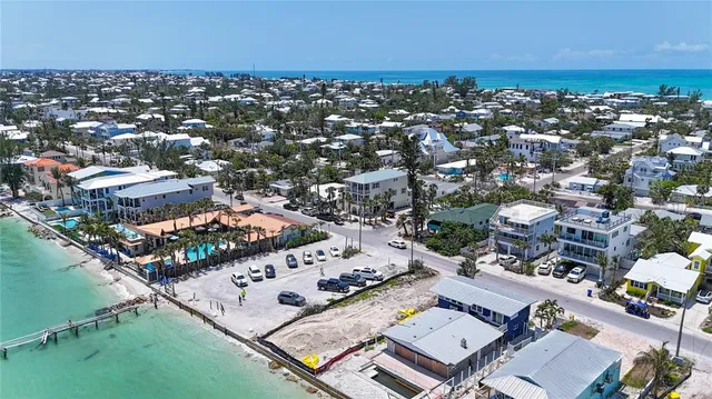 an aerial view of a city with ocean view