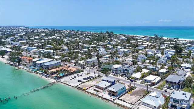 an aerial view of multiple house with a yard