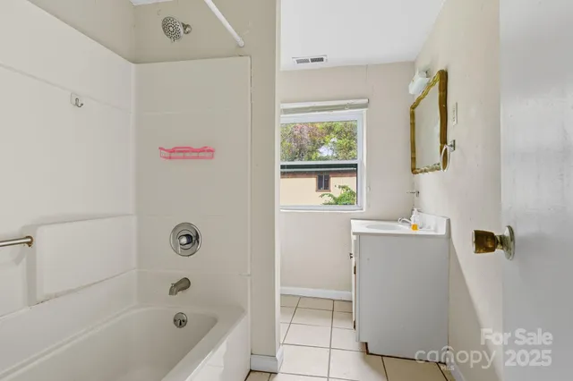 a bathroom with a bathtub sink and shower