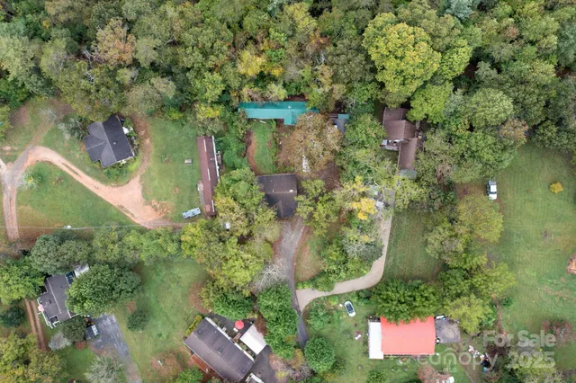 an aerial view of a house with a yard and fountain