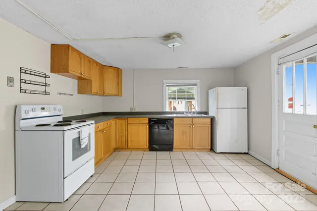 a kitchen with a white cabinets and white appliances
