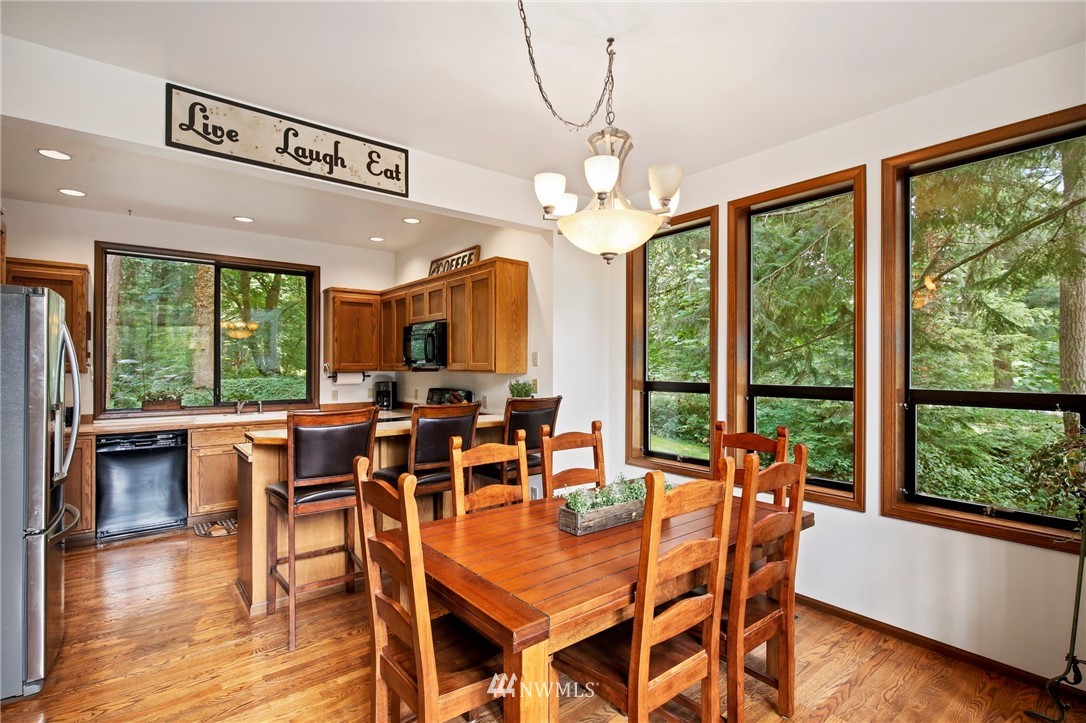 20830 Southeast 145th Street Renton, WA 98059 - Photo 7 of 39 a view of a dining room with furniture window and wooden floor