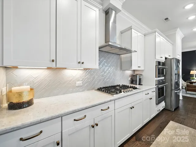a living room with furniture a window and a potted plant