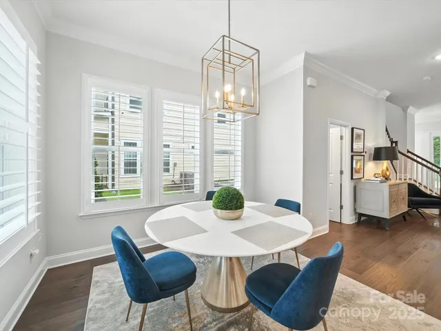 a spacious bedroom with a bed and a chandelier