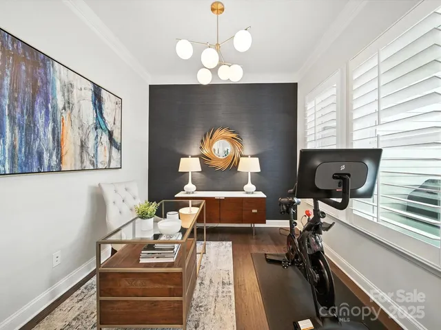 a living room with couches a coffee table and a chandelier with wooden floor