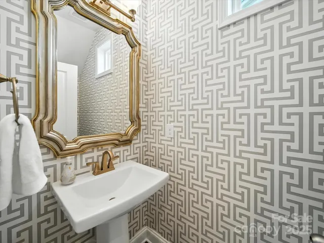 a living room with furniture and paintings on the wall