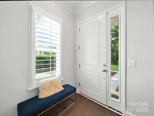 a kitchen with stainless steel appliances granite countertop a sink a stove and a white cabinets