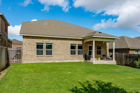 a front view of house with a garden and patio