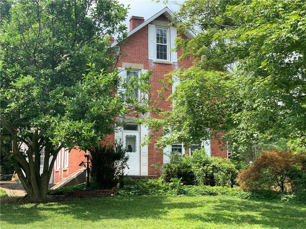 168 Boozel Road Slippery Rock, PA 16057 - Photo 1 of 24 a front view of a house with garden