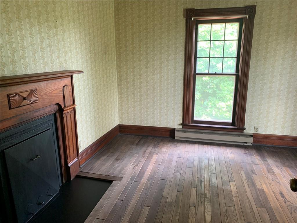 168 Boozel Road Slippery Rock, PA 16057 - Photo 16 of 24 an empty room with wooden floor and a window