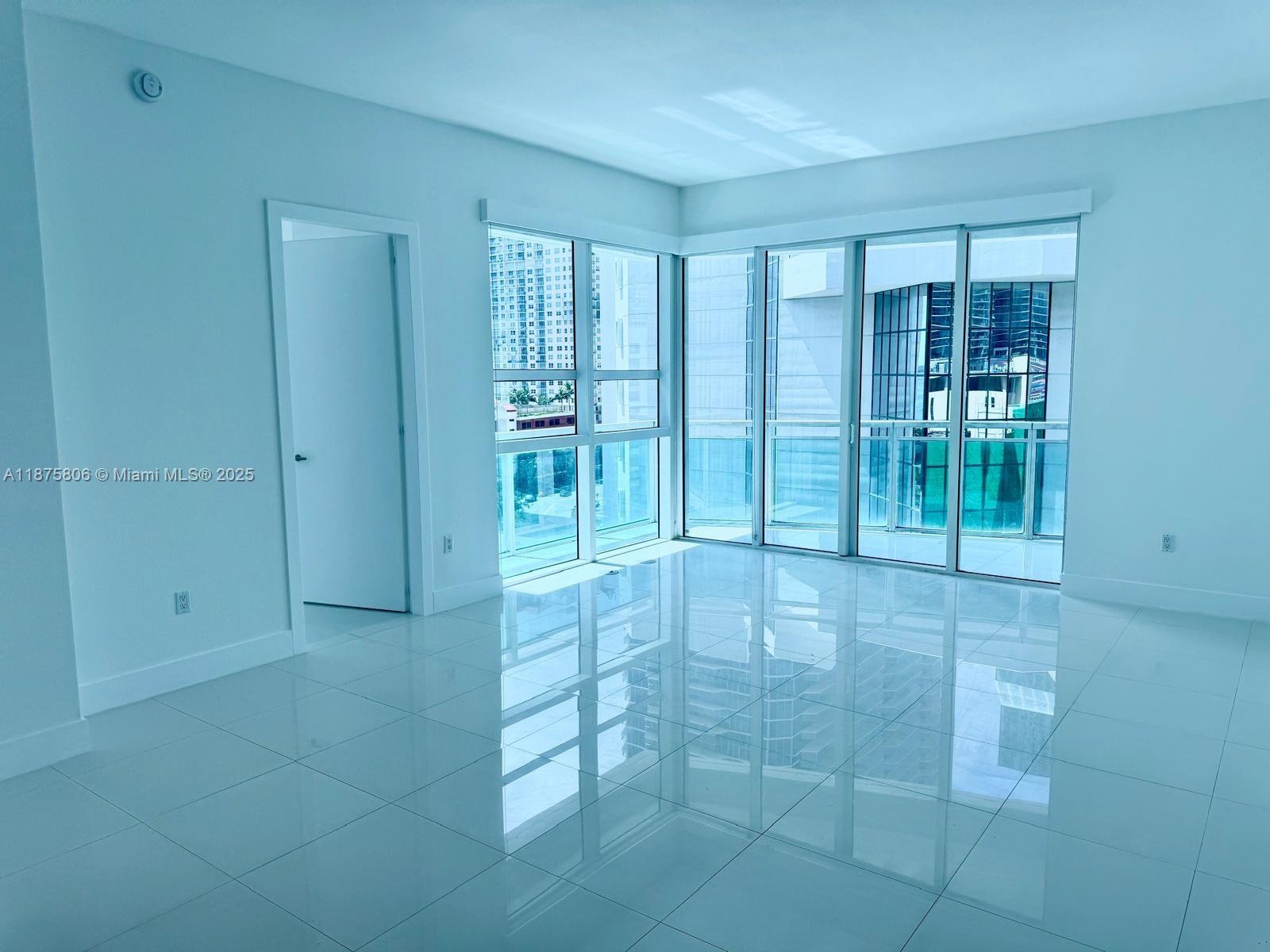 951 Brickell Avenue, Unit 1010 Miami, FL 33131 - Photo 1 of 23 a view of an empty room with a window