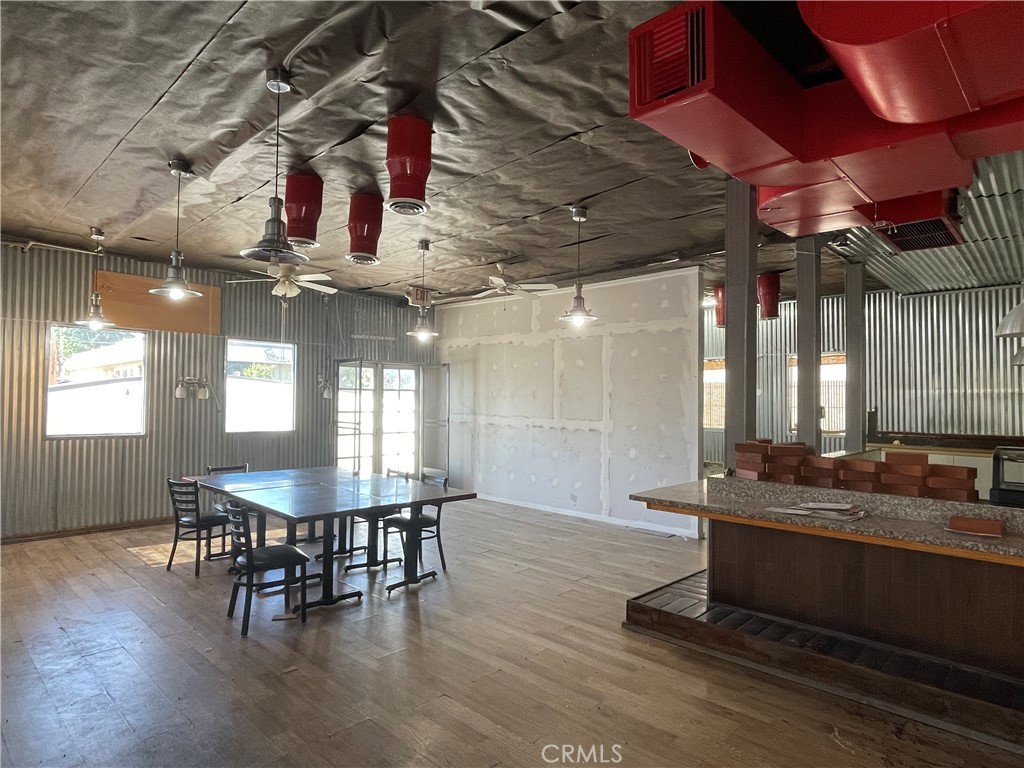 962 West Foothill Boulevard Claremont, CA 91711 - Photo 8 of 11 a dining hall with stainless steel appliances kitchen island granite countertop a table chairs and a window