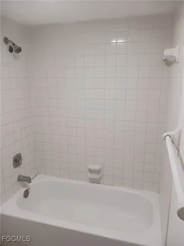a bathroom with a shower a toilet and a shower