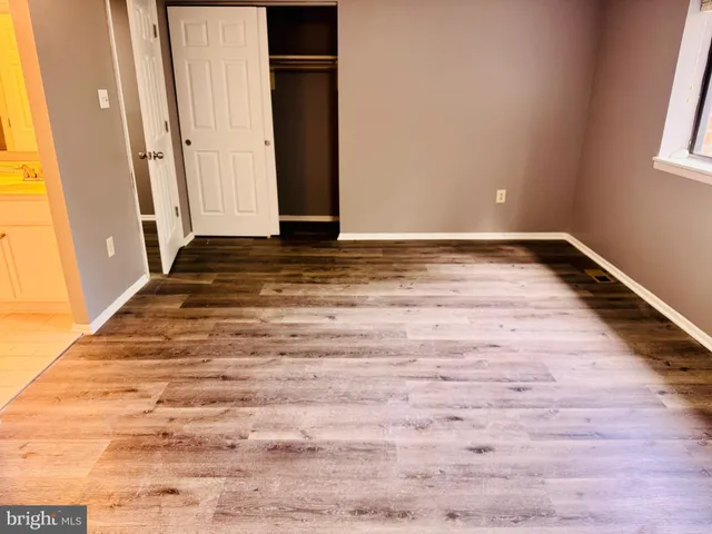 a view of a room with wooden floor and window