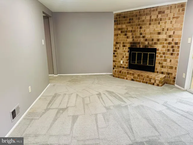 a view of an empty room with a fireplace