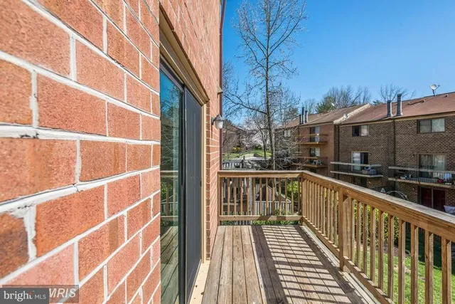 a view of balcony with wooden floor and fence