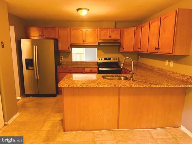 a kitchen with stainless steel appliances a refrigerator and a stove