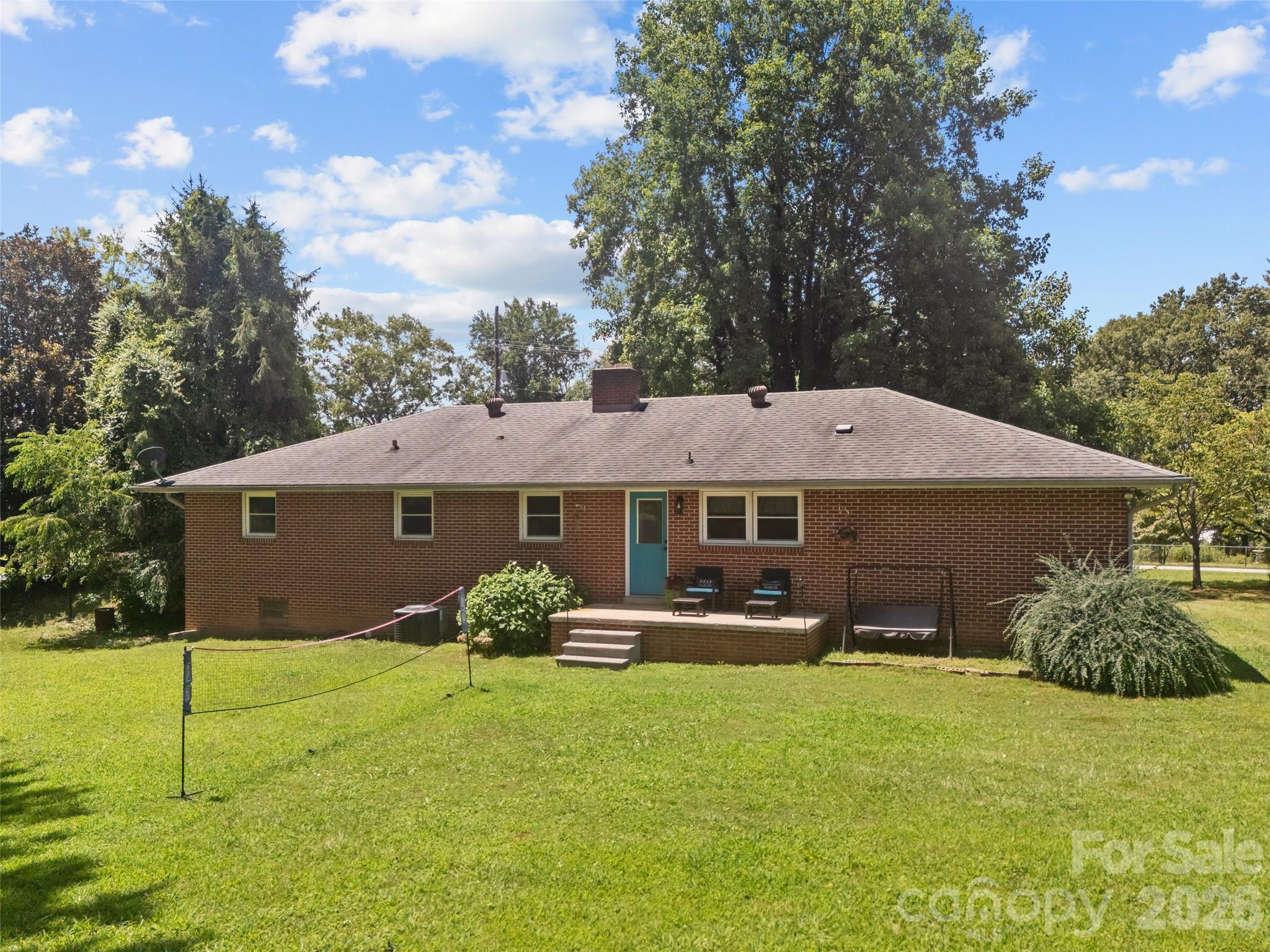 50 Baldwin Road Arden, NC 28704 - Photo 2 of 24 a backyard of a house with table and chairs
