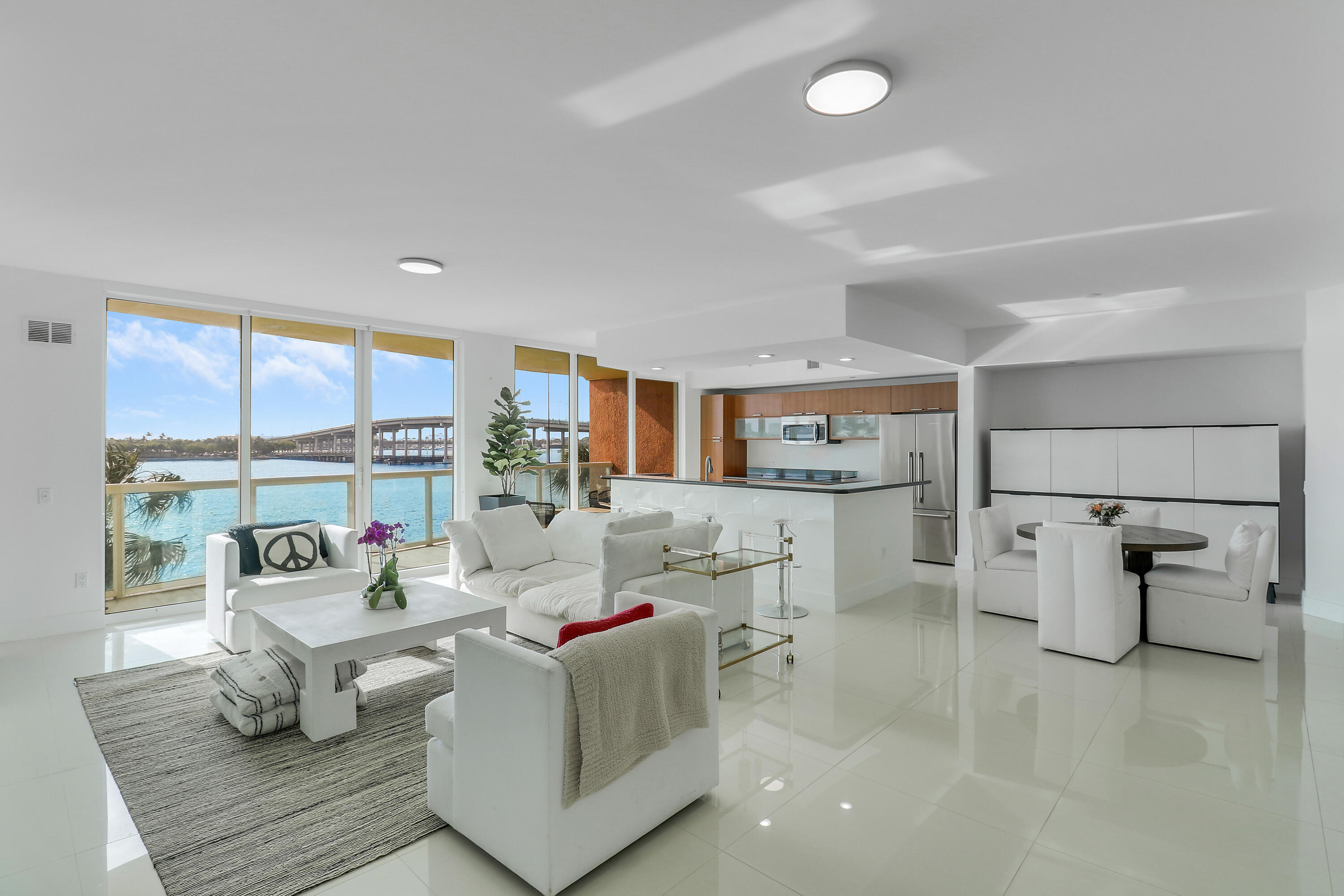 2640 Lake Shore Drive, Unit 307 Riviera Beach, FL 33404 - Photo 1 of 44 a living room with furniture and a table