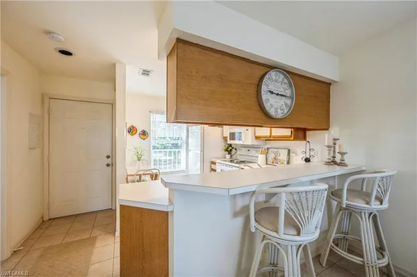 a kitchen with stainless steel appliances granite countertop a sink and a refrigerator