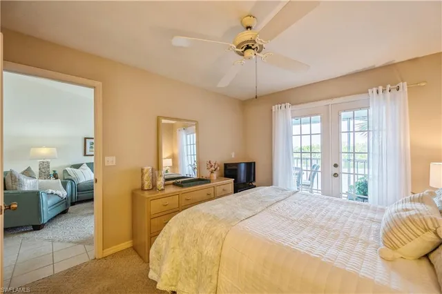 a bedroom with a bed and ceiling fan