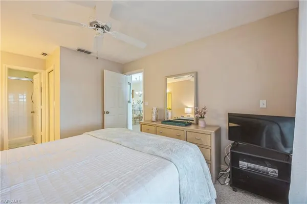 a bedroom with a bed and a television