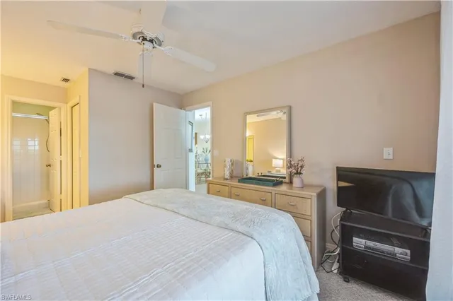 a bedroom with a bed and a television