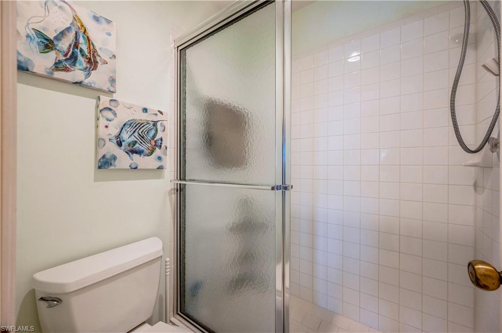 1325 Mainsail Drive, Unit 1213 Naples, FL 34114 - Photo 26 of 40 a bathroom with a shower and toilet