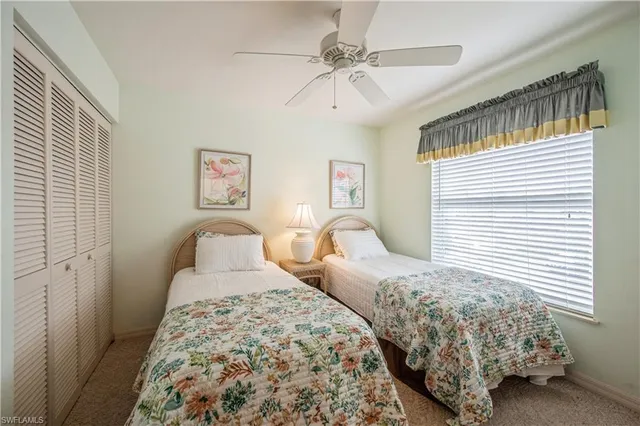 a bedroom with two beds and a table