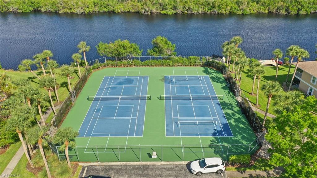 1325 Mainsail Drive, Unit 1213 Naples, FL 34114 - Photo 32 of 40 a view of a lake with a bench next to a lake