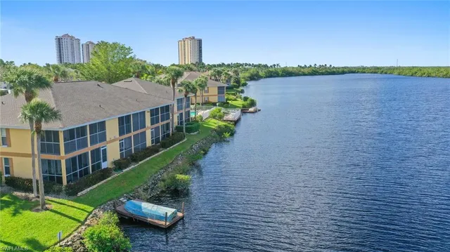 a view of a house with a yard and a lake view