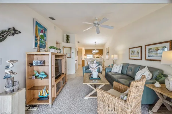 a living room with furniture and a floor to ceiling window