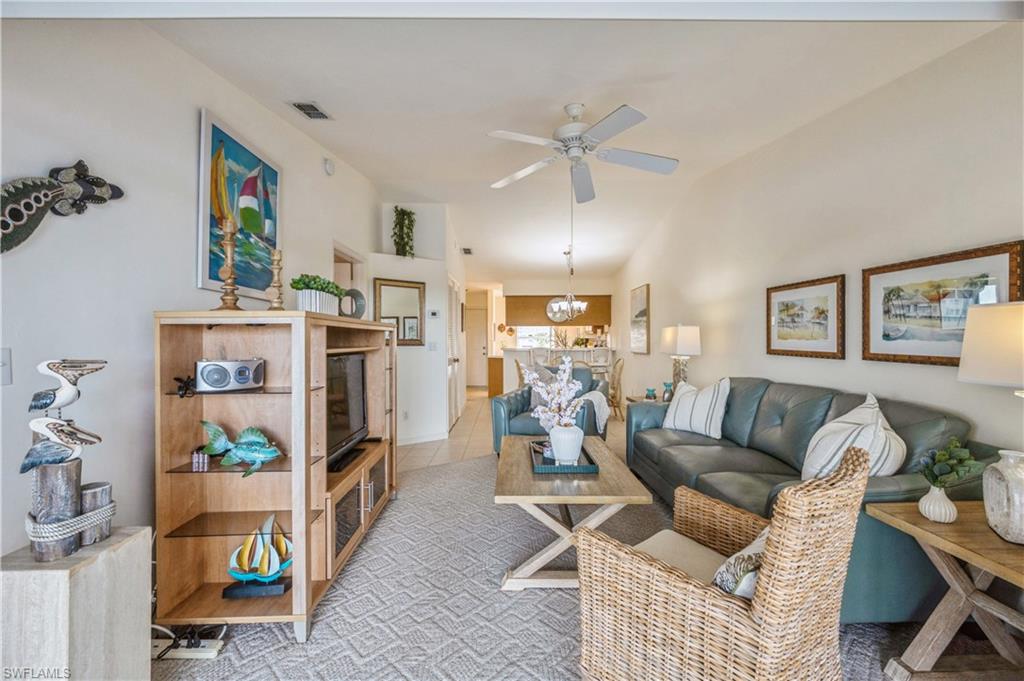 1325 Mainsail Drive, Unit 1213 Naples, FL 34114 - Photo 6 of 40 a living room with furniture and a floor to ceiling window